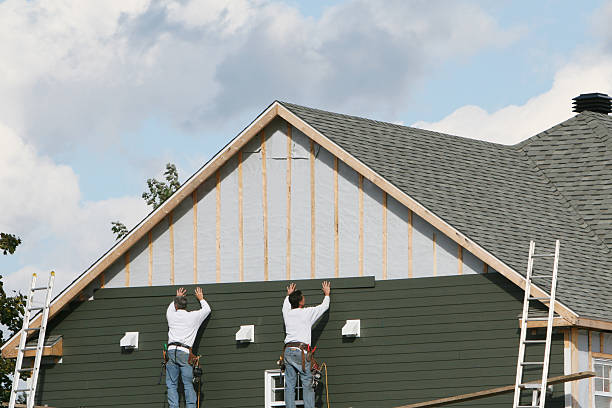 Professional Storm Damage Siding Repair technician working in Raymond, OH